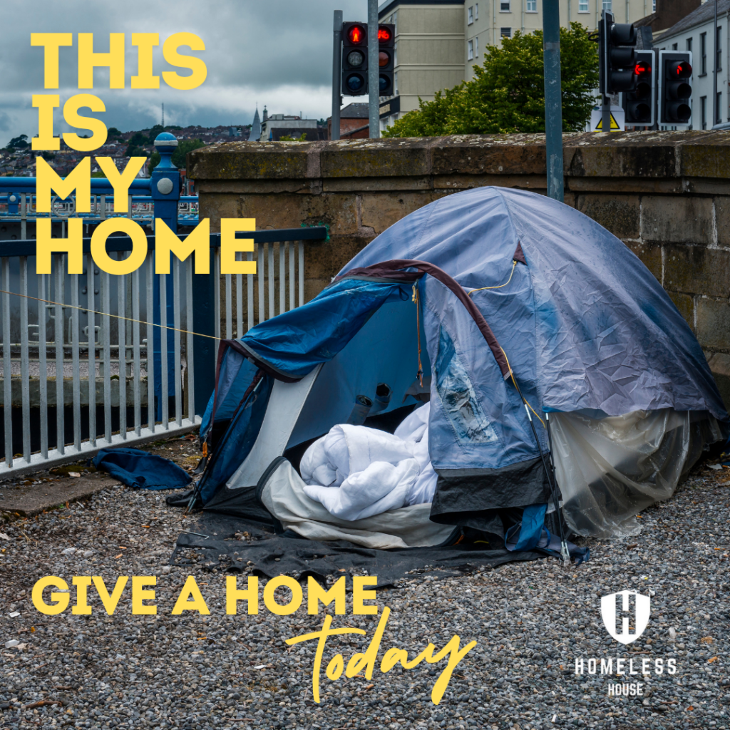 a tent next to a wall in a city centre - highlighting rough sleeping